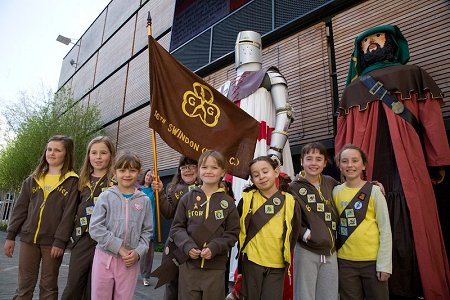 St. George statue standing under the BBC Big Screen in Wharf Green, with the 16th Swindon Girl Guides in the foreground