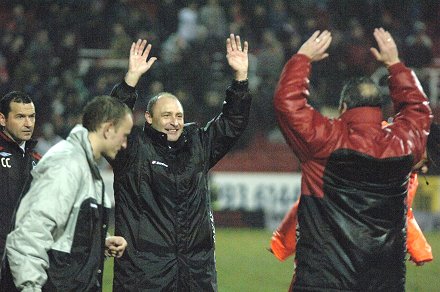 Maurice Malpas and Dave Byrne celebrate after Town's win - losing Forest manager looks on