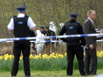 Police divers search the lake at Coate Water after a man's decomposed body was found