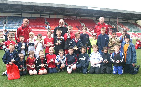 Swindon Town manager Maurice Malpas with youngsters from the Community Football initiative