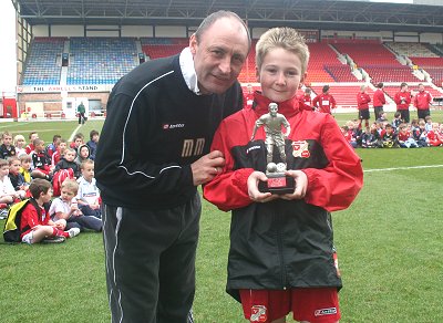 Swindon Town manager Maurice Malpas awards 10-year-old Calvin Smith