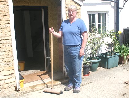 Haydon Wick resident Linda Brown in Swindon clearing up after the floods