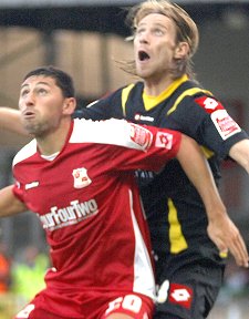 Swindon Town's Billy Paynter with QPR's Kaspars Gorkss