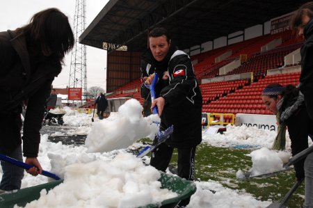 Danny Wilson Swindon Town Manager clearing the snow at the football club